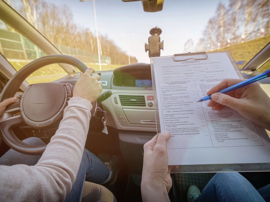 Instructor taking notes during a road test preparation lesson